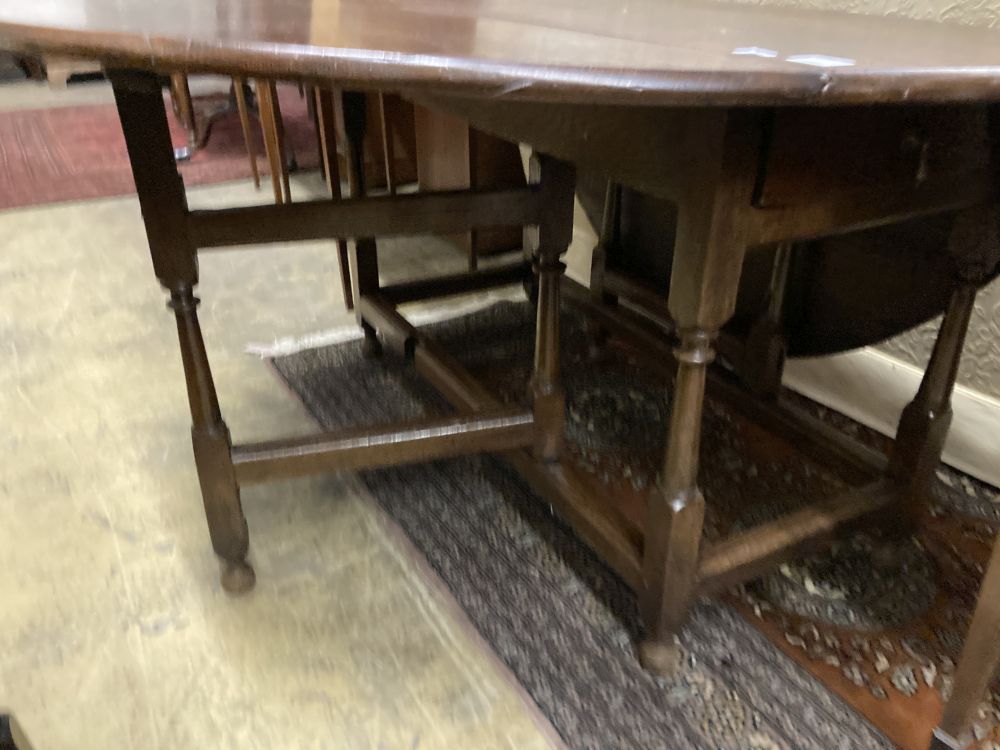 An 18th century oak oval topped gateleg dining table, fitted single drawer, width 130cm depth 50cm height 74cm